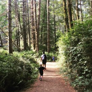 Boys running in Oregon forest